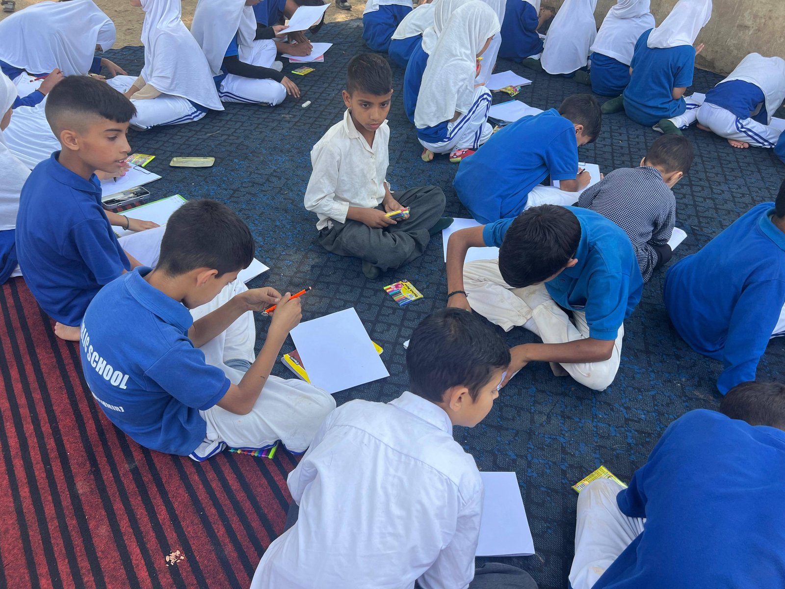 Children sharing drawings during an art and expression session